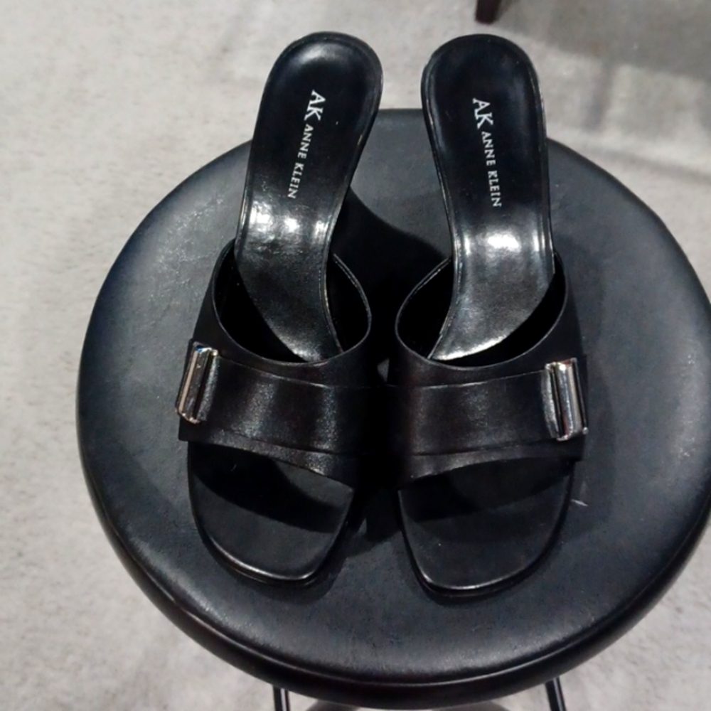 Anne Klein black leather mules.